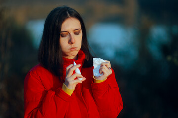 Sick Woman Using a Nasal Spray from a Congested Nose. Person suffering from rhinitis using a relief...