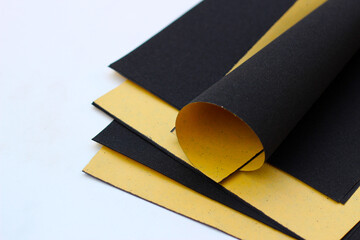Black sandpaper on a white background.