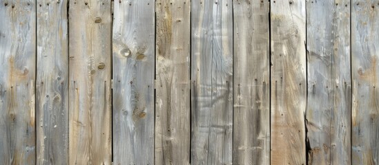 The image shows a close-up view of an old wooden fence, revealing the rough texture of weathered wood. The fence appears sturdy and well-built, with visible grains and knots.