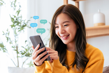 Fototapeta na wymiar Adorable young Asian woman using mobile smartphone. Online live chat chatting on application communication digital media website and social network