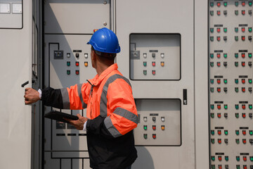 The electrical engineer checks and inspects at MDB panel (Main Distribution Board ) in the...