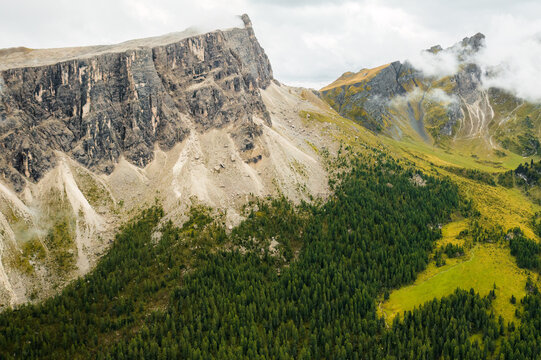 Stunning image of Rocky Dolomite Alps, where the lofty peak disappears into clouds