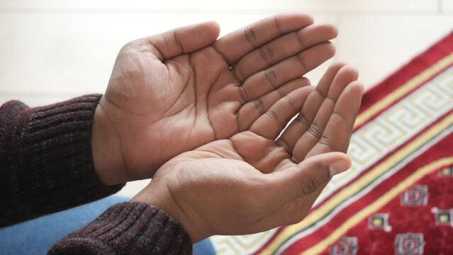 muslim man keep hand in praying gestures during ramadan, Close up 