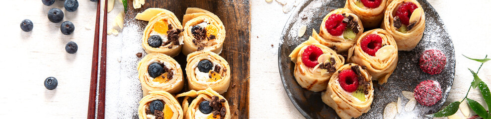 Asian sweet sushi pancake. Rolls with cream cheese berry and fruits.