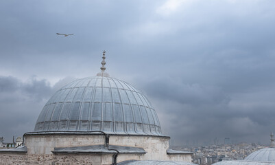 Fototapeta na wymiar Dome of mosque in Istanbul Turkey. Muslim mosque at cloudy day background.