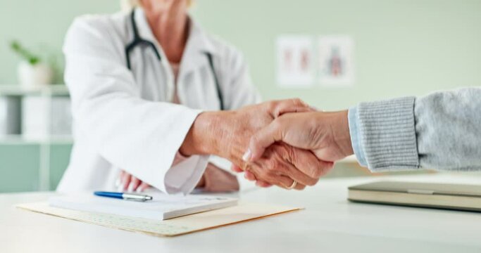 Doctor, prescription and handshake with patient for thank you, meeting or greeting at the clinic. Closeup of cardiologist or medical employee shaking hands with client for consultation or diagnosis