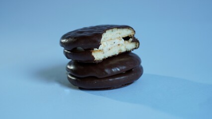 chocolate cookies on blue. Two cookies in chocolate choco pie closeup on a white. Isolated © Hai.. Zainul