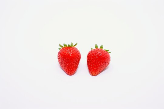 Ripe strawberries on light background, close-up food photography, deep depth of field