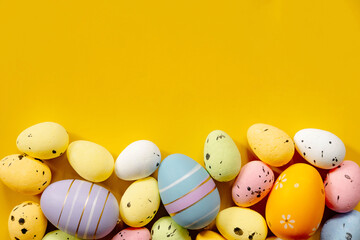 Multi-colored Easter eggs on a yellow spring background. Happy easter