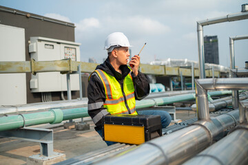 Fototapeta na wymiar Technician Using Measuring Equipment on Industrial Pipes