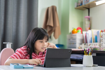 study online class by asian child back to school and smile on computer tablet or kid girl student video call studying or person happy learn from home by fun learning on pad in classroom at homeschool