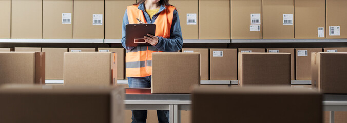 Worker checking parcels in the warehouse