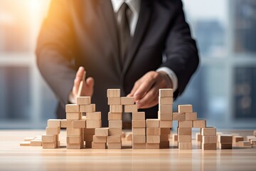 Businessman Building Blocks for Success. Wood block arranging on wooden table for Change, Growth and Competition. Business and Startup Concept