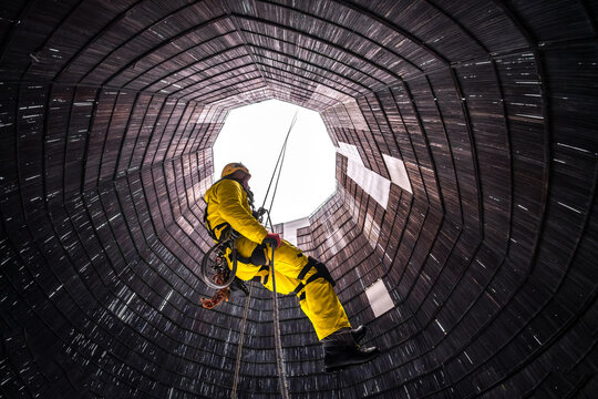 Rope access specialist in a cooling tower. A worker inspects the building