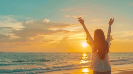 Fototapeta premium Rear view Beautiful asian woman stretching arm up into sky feeling happy at the beach with sunset.