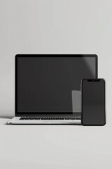 A laptop, phone, and tablet on a white surface. Perfect for technology concepts