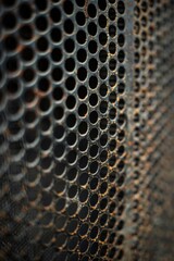 Detailed shot of a metal grate with holes. Ideal for industrial or architectural projects
