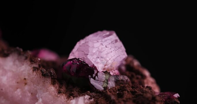 Cobalt-bearing calcite (pink) with roselite, (red) and cobaltoaustinite (green). macro 360&deg; full rotation
in 4k. detail. From Aghbar mine, Bou Azzer, Morocco 
