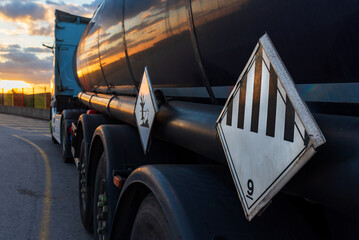 Danger labels on a tanker truck with dangerous goods, with the number nine of various dangers and...