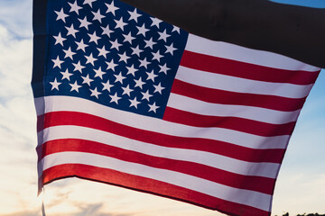 Waving American Flag on sun Background. Flag of the united states of America. July 4th Independence...