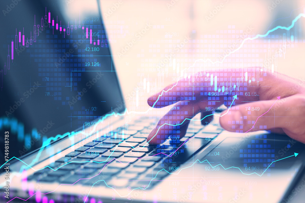 Poster close up of businessman hands using laptop on desk with creative glowing candlestick forex chart on 