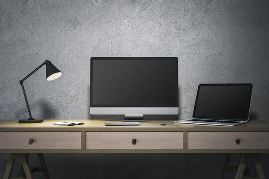 Modern minimalistic designer office interior with blank computer and laptop monitors. Mock up, 3D Rendering.