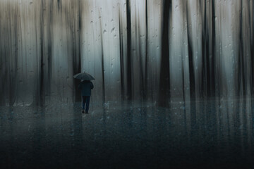 silhouette of a man walking in the rain