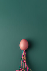 Creative easter concept. Easter egg in the shape of a rocket on dark green background with copy space.