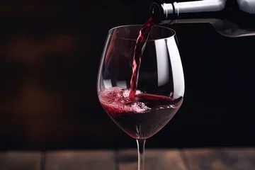 Fotobehang Pouring red wine to glass party restaurant bar gourmet celebration luxury taste splashing grape alcohol expensive drink bordeaux chateu cabernet bottle refreshment toned drops bubbles french wineglass © Yuliia