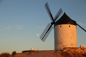 Beautiful Windmill during Sunset and Moon in the Sky (Consuegra Spain)