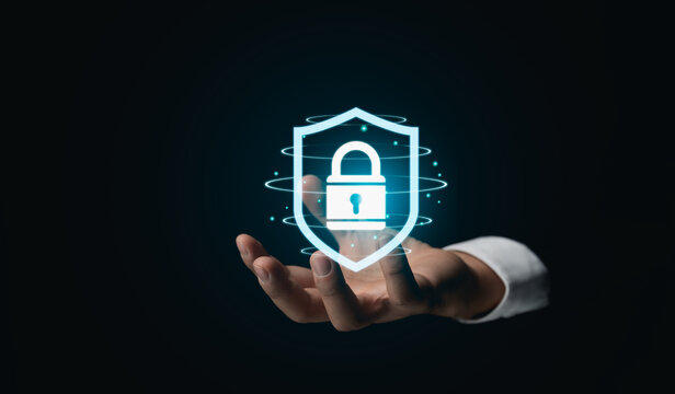 Hand Presenting Virtual Security Shield Symbol. An outstretched hand holding displays a glowing virtual security shield, symbolizing advanced protection in the digital age. Cyber Security concept. - Powered by Adobe