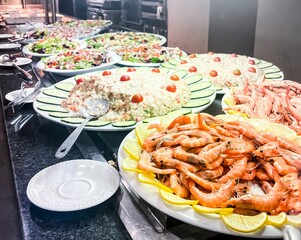 Assortment of starters, seafood and salads in a hotel self-service restaurant.