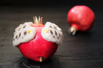 Concept, the king is dead, long live the king. The fruit, pomegranate is dressed in the king's mantle, symbolizing the leader among fruits due to its valuable properties and royal appearance. Creative