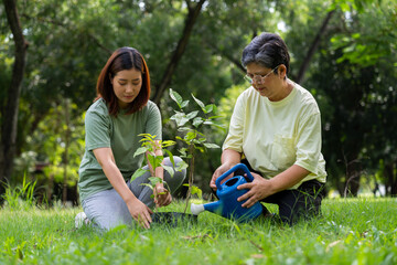 Old Asian Women and daughter join as volunteers for reforestation, earth conservation activities for reduce global warming growth feature and take care nature earth. Environment Concept