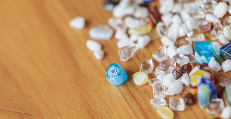 Colorful beads scattered on wooden surface