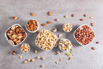 Healthy mix nuts and dried fruits on wooden background. Almonds, hazelnuts, cashews, peanuts, pistachios, Brazilian nuts