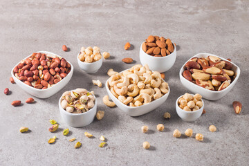 Healthy mix nuts and dried fruits on wooden background. Almonds, hazelnuts, cashews, peanuts, pistachios, Brazilian nuts