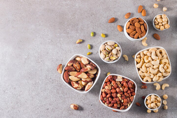 Healthy mix nuts and dried fruits on wooden background. Almonds, hazelnuts, cashews, peanuts, pistachios, Brazilian nuts