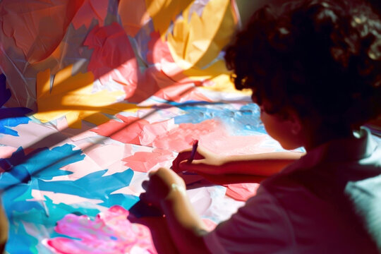 Capture inspiration with this vibrant image of a person engaged in colorful paper crafts