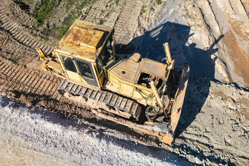 Bulldozer during the construction of a new road. Top view of a powerful working bulldozer....
