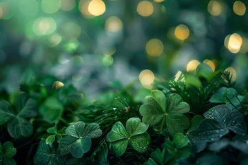 Foto op Canvas A green background, a happy Irish four-leaf clover in a field and with three-leafed ones is a symbol of the St. Patrick's Day holiday. © Tonya