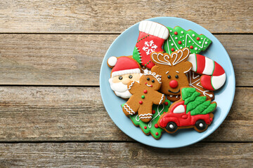 Different tasty Christmas cookies on wooden table, top view. Space for text