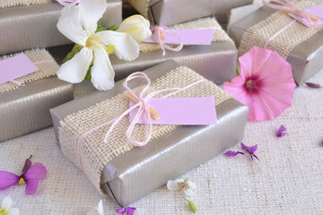 Obraz na płótnie Canvas Silver wedding anniversary favors gift box with jute ribbon flowers, handmade soap guest souvenir