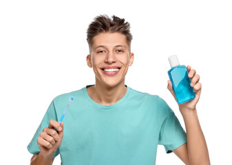 Young man with mouthwash and toothbrush on white background