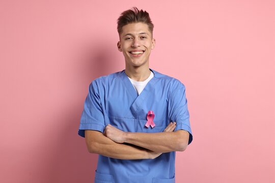 Mammologist with pink ribbon on color background. Breast cancer awareness - Powered by Adobe