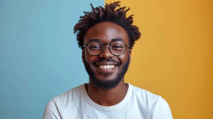  a close up of a person wearing glasses and a white t - shirt with a yellow and blue wall in the background and a yellow and blue wall behind him. - obrazy, fototapety, plakaty