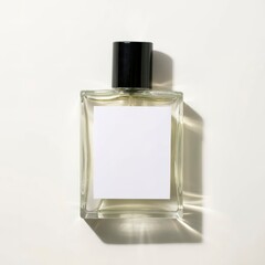 A clean mockup of a bottle of perfume with label isolated on white background top view