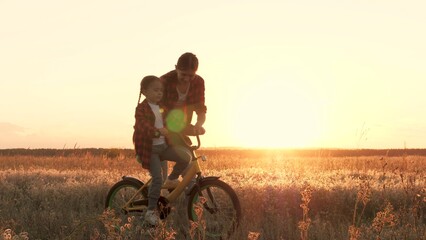 mother teaches child kid ride bike park, experiencing moments happiness under evening sunset, family joys, mother dream teaching child ride bike comes true against backdrop sunset park, sunset dream