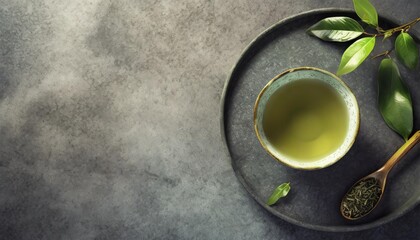 Obraz na płótnie Canvas green japanese tea on stone table top view with copy space