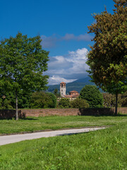 View of Sant'Anna Church old bell tower from Lucca city ancient walls park
